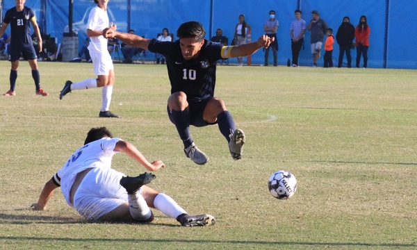 FC Sophomore Captain Steve Perez leaps over a SCC defender.