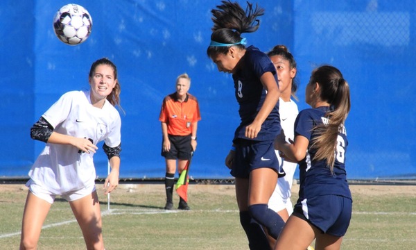 Ashley Bautista headers the ball for a shot attempt.